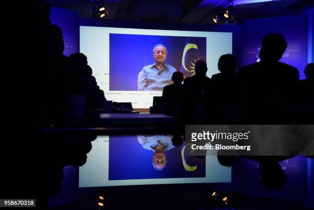 Mahathir Mohamad, Malaysia's prime minister, is displayed on a screen while speaking via a video link to the participants at the Wall Street Journal...