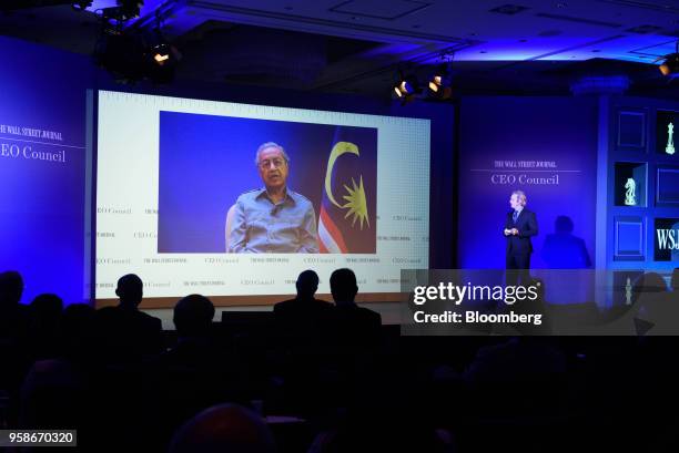 Mahathir Mohamad, Malaysia's prime minister, is displayed on a screen while speaking via a video link to the participants at the Wall Street Journal...