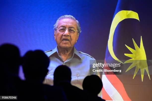 Mahathir Mohamad, Malaysia's prime minister, is displayed on a screen while speaking via a video link to the participants at the Wall Street Journal...