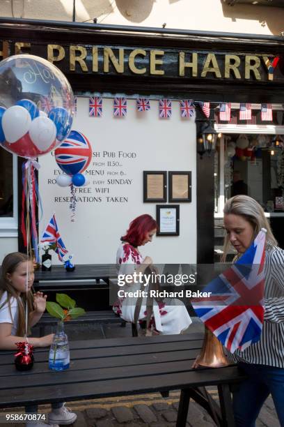 Flags and balloons outside the Prince Harry pub in the old town of Windsor as it gets ready for the royal wedding between Prince Harry and his...