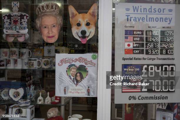 Tourist currency rates and royal family souvenirs and merchandise on sale in a tourist gift shop window as the royal town of Windsor gets ready for...