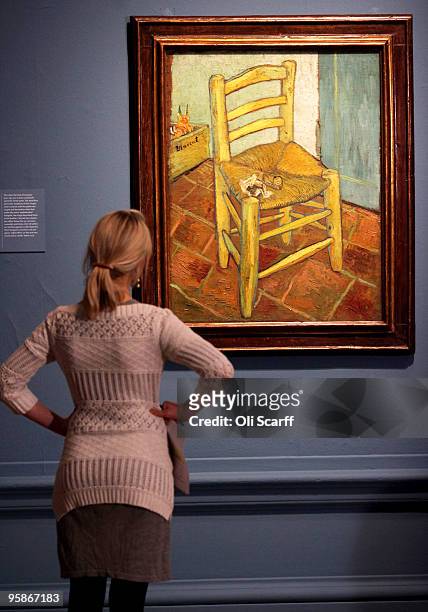 Woman admires an oil painting by acclaimed Dutch artist Vincent Van Gogh entitled "Van Gogh's Chair" in an exhibition of his work held at the Royal...