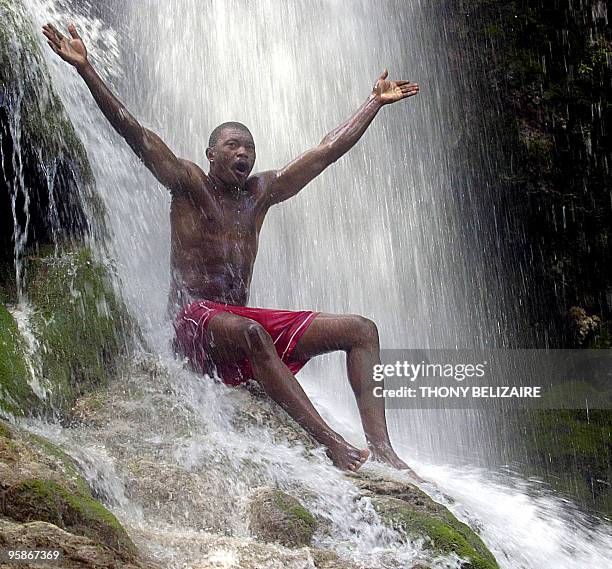 Haitian man bathes in the waterfalls 16 July, 2007 during a Voodoo pilgrimage and festival of the Miracle Virgin of Saut D'Eau in Saut D'Eau, some 60...