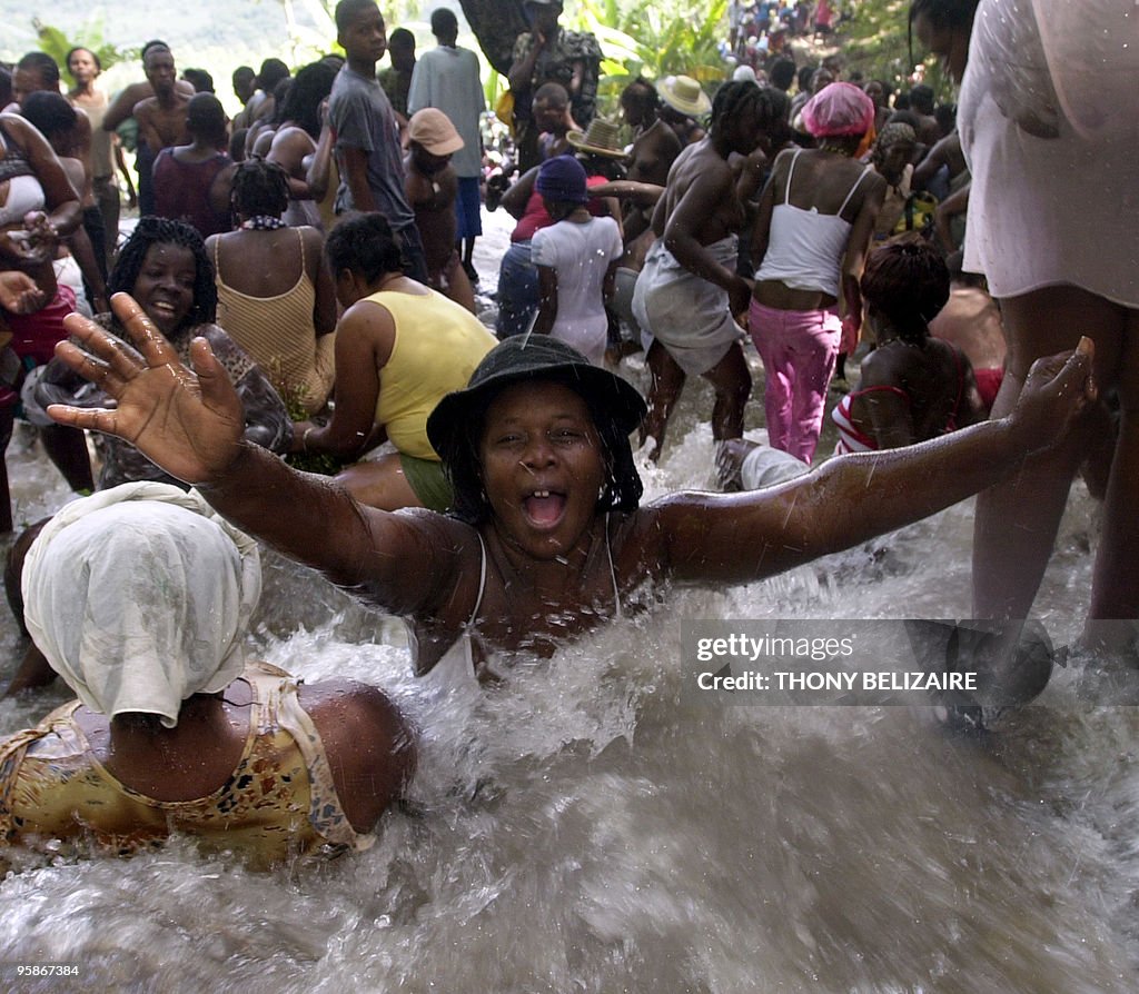 Haitians bathe in a waterfall 16 July, 2