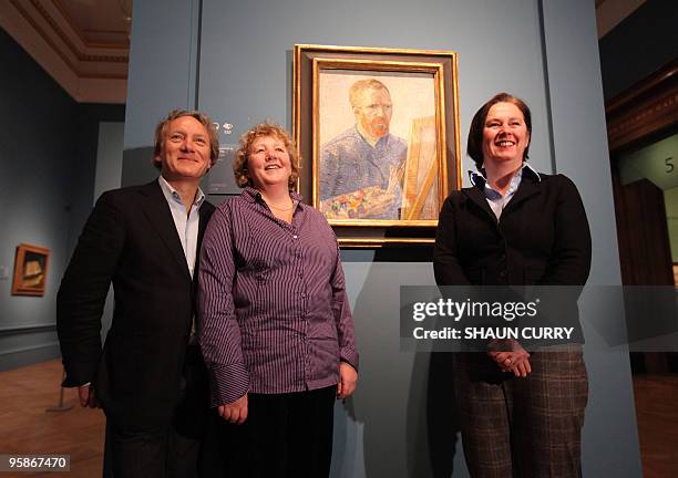 Members of the Van Gogh family pose for photographs alongside a self portrait of Dutch artist Vincent Van Gogh at the opening of an exhibition of the...