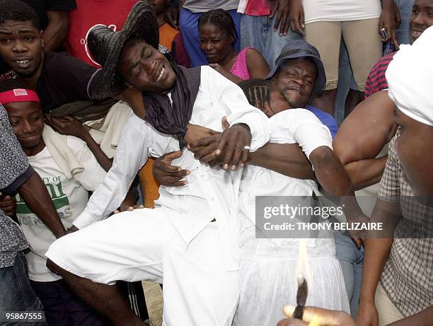 Voodoo faithful go into a trance 02 November 2007 during a celebration of the Day of the Dead in the Petion-ville neighborhood of Port-Au-Prince. The...