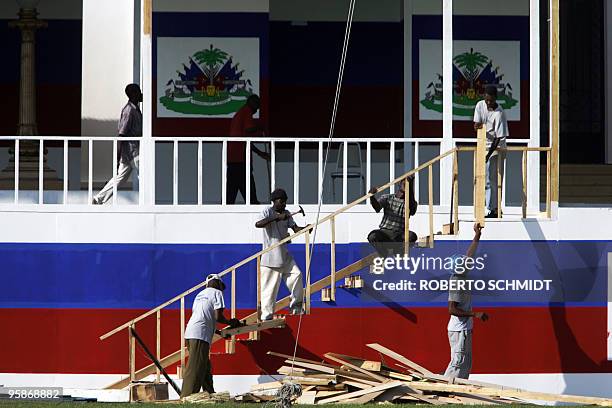 Haitian men work together to build a stage in the front lawn of the Presidential Palace in Port-Au-Prince, Haiti 12 May 2006 two days before...