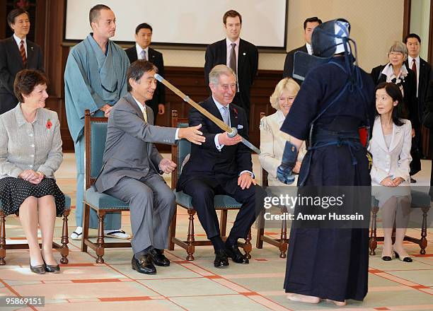 Prince Charles, Prince of Wales receives a bamboo sword from Kendo sword fighter at the Emerging Museum of Science and Innovation on October 28, 2008...