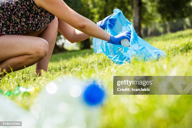 collecting trash in the local park - ivanjekic stock pictures, royalty-free photos & images