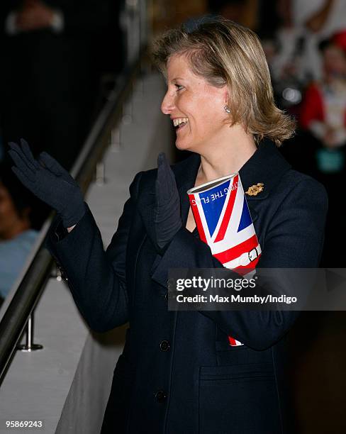 Sophie, Countess of Wessex carries a 'Papa Razzi' Union Jack Flag clutch style handbag, emblazoned with the slogans "Britannia Rules" and "Flying The...