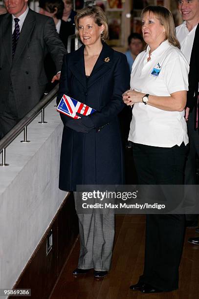 Sophie, Countess of Wessex carries a 'Papa Razzi' Union Jack Flag clutch style handbag, emblazoned with the slogans "Britannia Rules" and "Flying The...