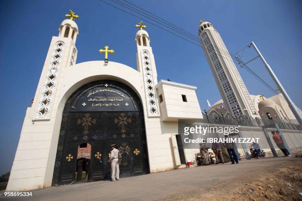 Egyptians stand outside the Coptic Orthodox Church of the Martyrs in the village of Al-Our in the southern Minya province on May 15 during the...