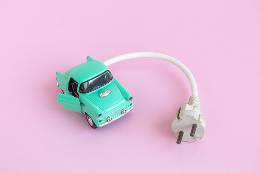 Small retro car with electric cable.