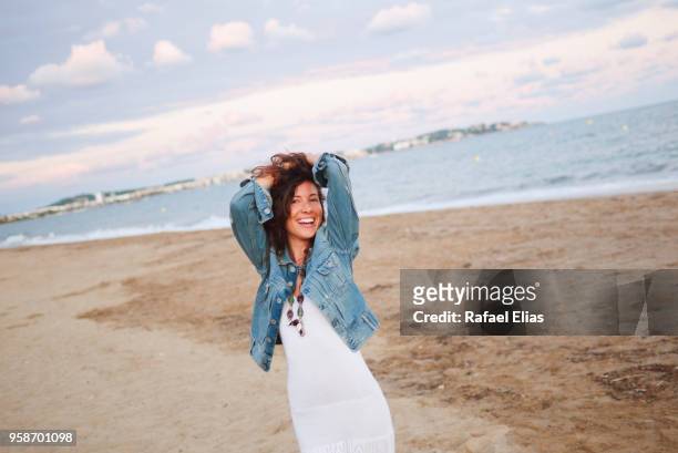 happy woman on the beach - costa dorada stock pictures, royalty-free photos & images