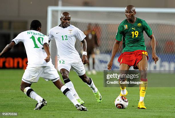 Stephane Mbia of Cameroon comes under pressure from James Chamanga and Thomas Nyirenda of Zambia during the African Nations Cup group D match between...