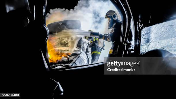 bomberos usando extintor - carro de bombeiro fotografías e imágenes de stock