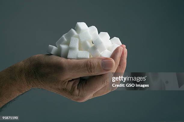 handfull of sugar cubes - sugar ストックフォトと画像