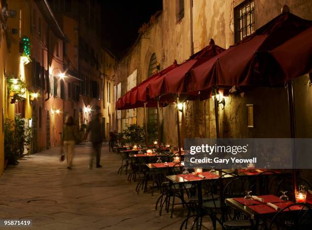 tourists walking in street at night  - gary bond stock pictures, royalty-free photos & images