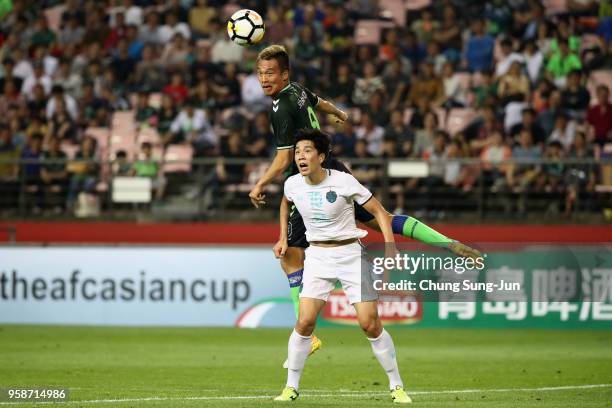 Kim Shin-Wook of Jeonbuk Hyundai Motors outjumps Yoo Jun-Su of Buriram United during the AFC Champions League Round of 16 second leg match between...