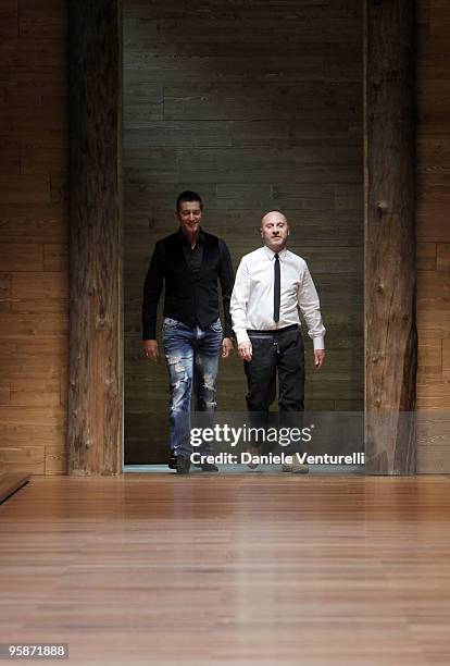 Designers Stefano Gabbana and Domenico Dolce acknowledge the applause of the public after the D&G Milan Menswear Autumn/Winter 2010 show on January...
