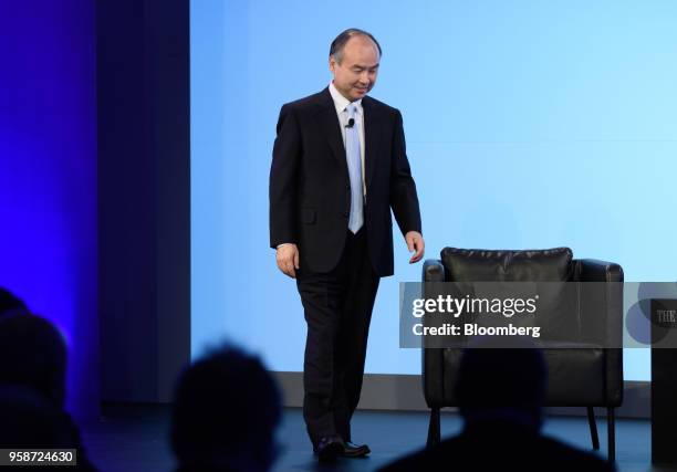 Masayoshi Son, chairman and chief executive officer of SoftBank Group Corp., walks on stage during the Wall Street Journal CEO Council in Tokyo,...