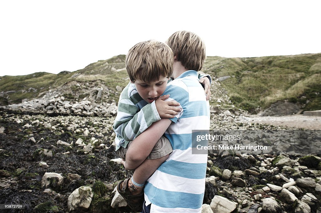 Boy carrying younger brother