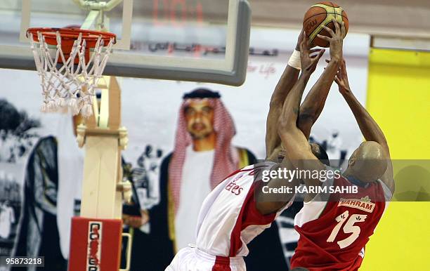 Of Lebanon's Al-Riyadi club jumps for the ball with Ioren Woods of Iran's Mahram club during the 21st Dubai International Basketball Championship on...