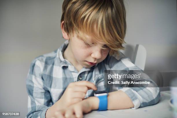 child using a smart watch - smart watch stock pictures, royalty-free photos & images