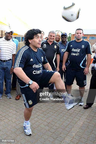 In this handout photo provided by 2010 FIFA World Cup Organising Committee South Africa, Argentina national soccer team's head coach Diego Maradona...