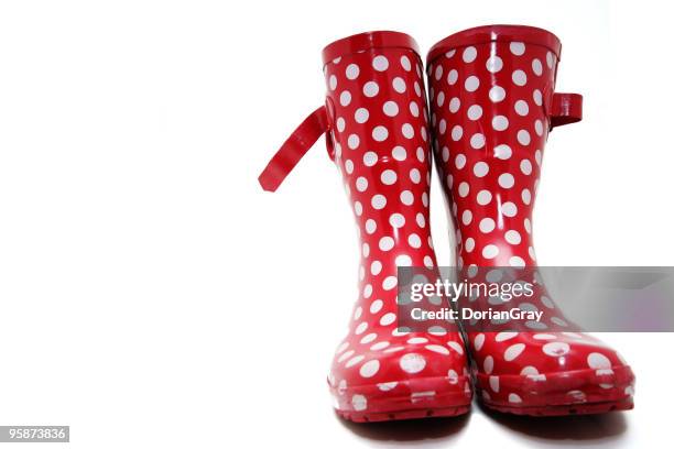 red wellington boots with white spots on a white background - rubberlaars stockfoto's en -beelden