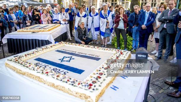 Members of Christians for Israel share cake at during a public celebration in honor of the seventy-year existence of the state of Israel in The Hague...