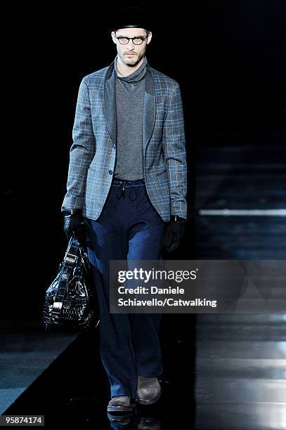 Model walks the runway during the Giorgio Armani Stampa Milan Menswear Autumn/Winter 2010 show on January 19, 2010 in Milan, Italy.