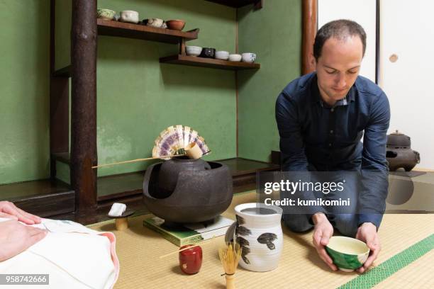 caucasian man enjoy tea ceremony - japanese tea cup stock pictures, royalty-free photos & images