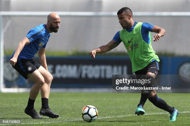 Rafinha Alcantara is challenged by Borja Valero during the FC Internazionale training session at the club's training ground Suning Training Center in...