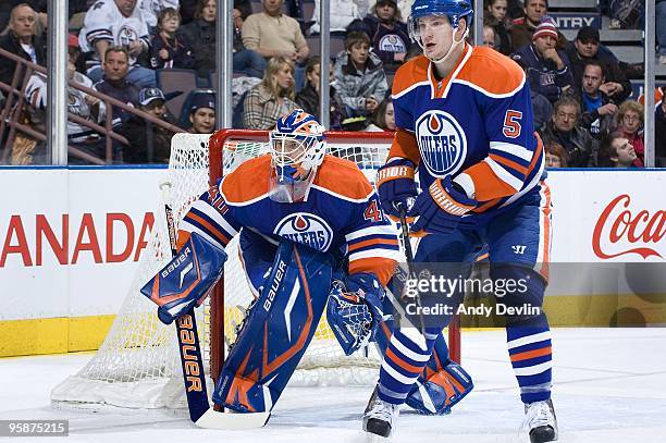 Devan Dubnyk and Ladislav Smid of the Edmonton Oilers defend the front of the net during a game against the Nashville Predators at Rexall Place on...