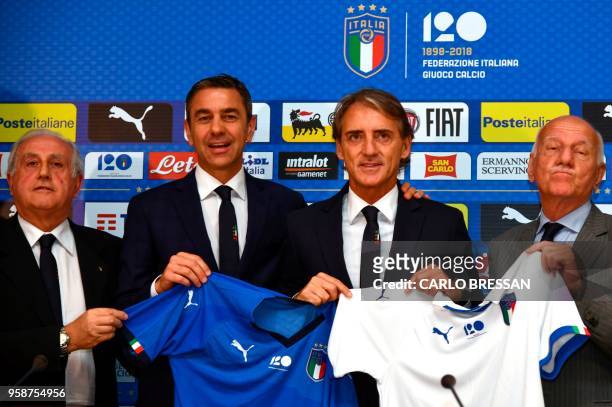 Italy's national football team newly appointed head coach, Roberto Mancini poses with members of the Italian football federation , Alessandro...