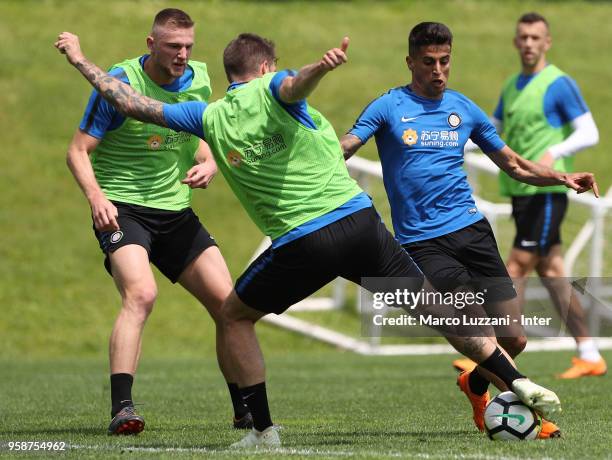 Joao Cancelo is challenged by Davide Santon during the FC Internazionale training session at the club's training ground Suning Training Center in...