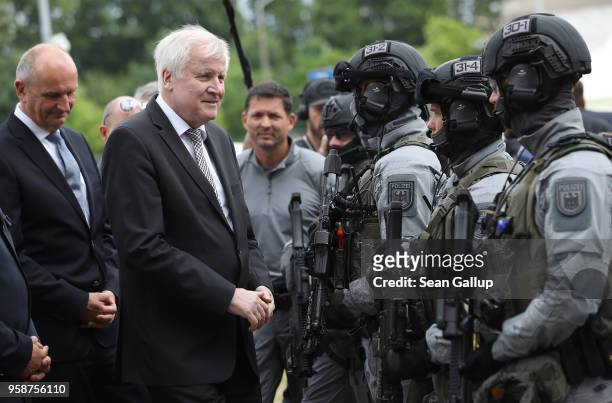 German Interior Minister Horst Seehofer and Brandenburg state Governor Dietmar Woidke chat with members of the federal police BFE Plus anti-terror...