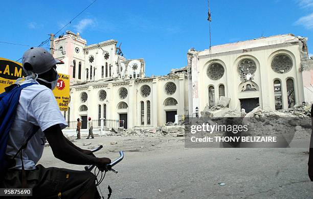 Haitian earthquake survivor views the damaged catheral on January 19 2010 in Port-au-Prince, Haiti. The United States expects to transition "very...