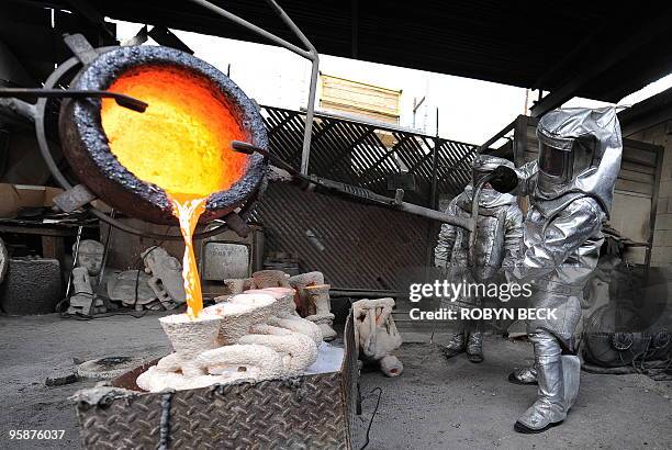 Workers pour molten bronze into an "Actor" statuette mold at the American Fine Arts Foundry in Burbank, California, January 19, 2010. The statuettes...
