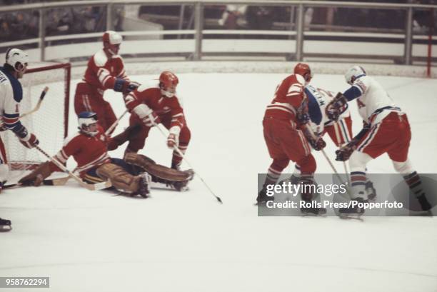 View of action between the United States and Switzerland in the Men's ice hockey tournament at the 1972 Winter Olympics at the Makomanai Ice Arena in...