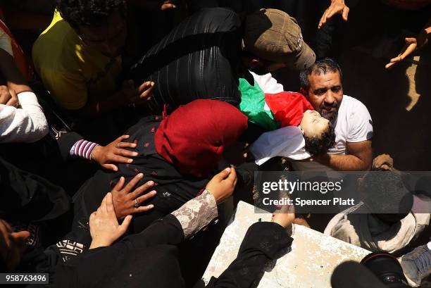 The body of eight-month-old Leila Anwar Ghandoor, who died in hospital on Tuesday morning from tear gas inhalation, is placed into a grave on May 15,...