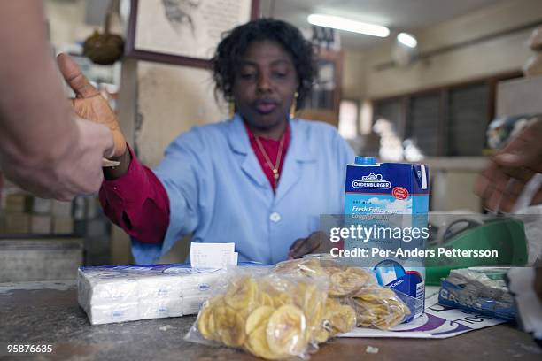 Customer buys imported milk powder from Europe in a super market on August 6, 2009 in Bamenda, Cameroon. Many small farmers in the area are...
