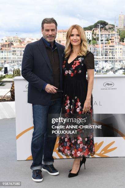 Actor John Travolta and his wife US actress Kelly Preston pose on May 15, 2018 during a photocall for the film "Gotti" at the 71st edition of the...