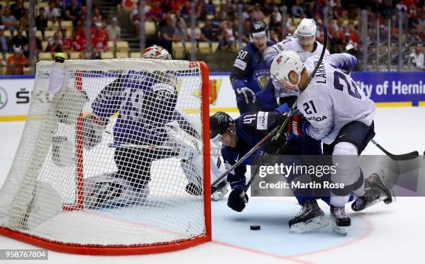 Miro Heiskanen of Finland and Dylan Larkin of the United States battle for the puck during the 2018 IIHF Ice Hockey World Championship Group B game...