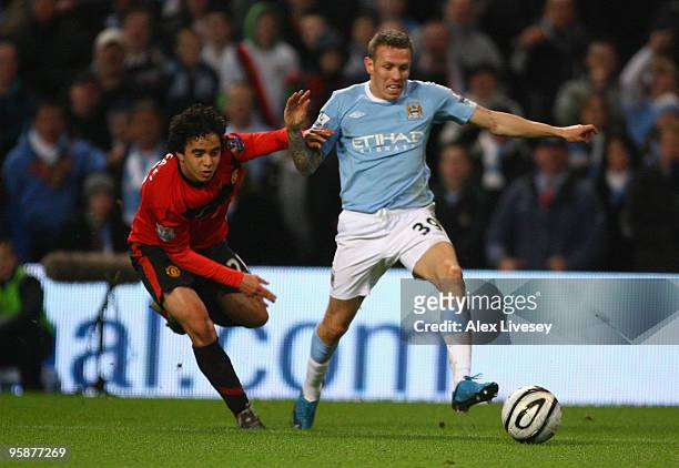 Rafael Da Silva of Manchester United brings down Craig Bellamy of Manchester City to concede a penalty during the Carling Cup Semi Final match...