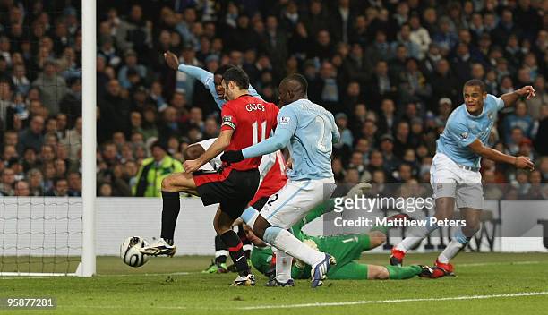 Ryan Giggs of Manchester United scores their first goal during the Carling Cup Semi-Final First Leg match between Manchester City and Manchester...