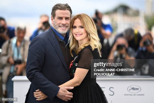 Actor John Travolta and his wife US actress Kelly Preston pose on May 15, 2018 during a photocall for the film "Gotti" at the 71st edition of the...