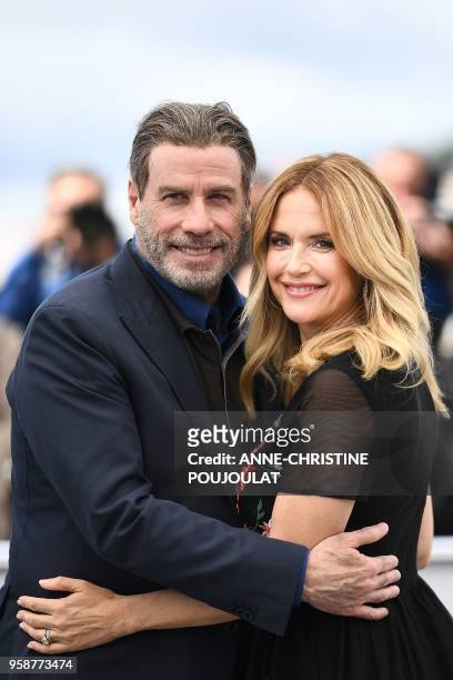 Actor John Travolta and his wife US actress Kelly Preston pose on May 15, 2018 during a photocall for the film "Gotti" at the 71st edition of the...