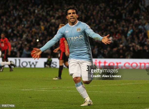 Carlos Tevez of Manchester City celebrates scoring his team's first goal during the Carling Cup Semi Final match between Manchester City and...